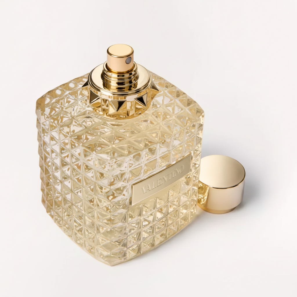 Valentino Donna Born in Roma Gold perfume bottle uncapped close-up showing gold spray nozzle